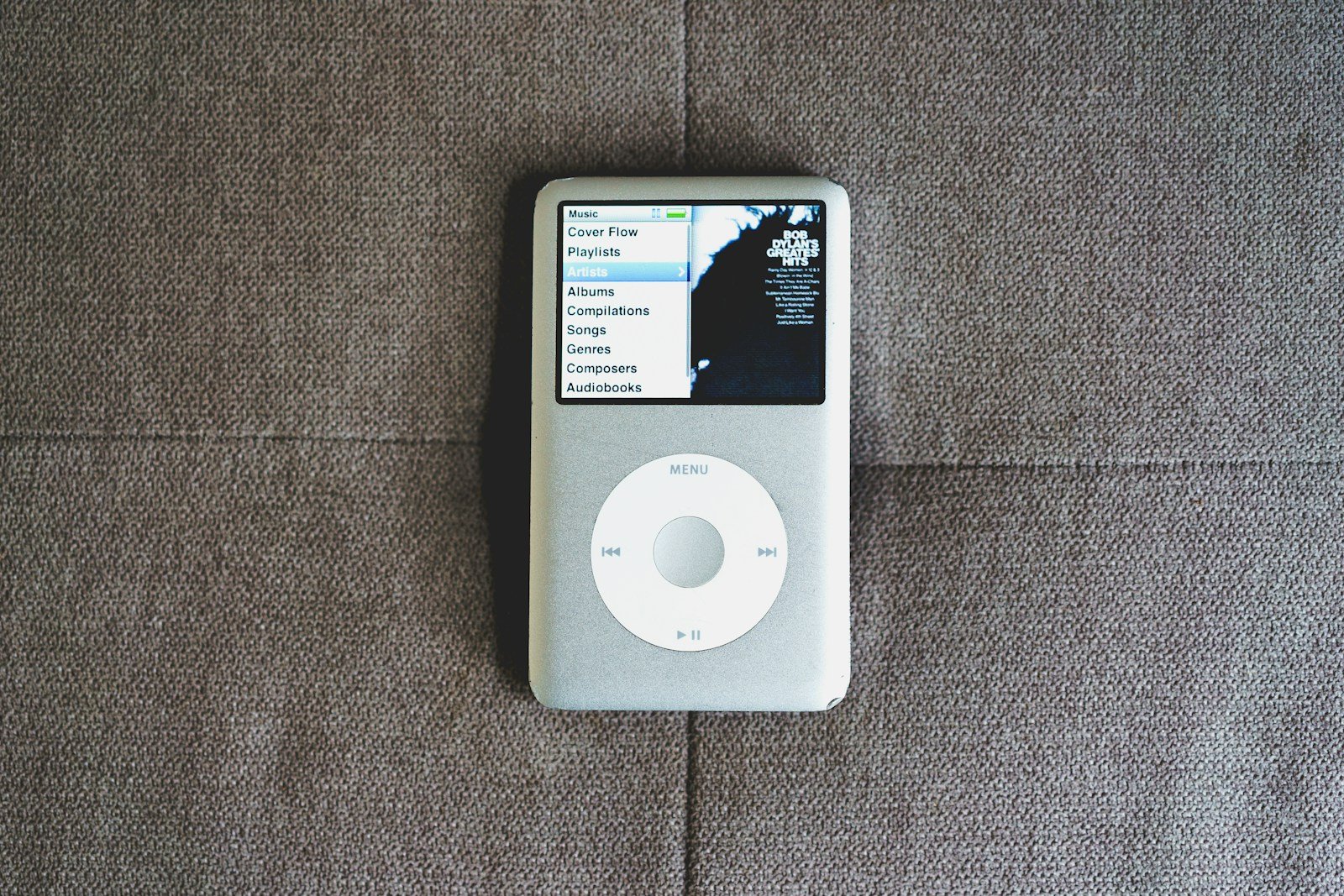 an ipod sitting on top of a couch